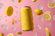 Close up of yellow empty can with water drops surrounded by flying lemons and ice cubes on pink background	