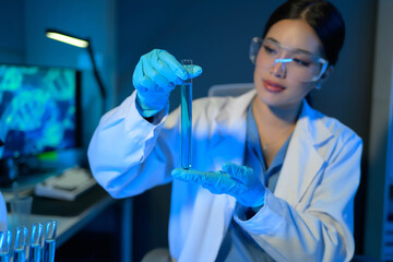 Wall Mural - A woman in a lab coat holding a test tube