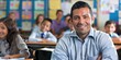 © Wattana - Handsome teacher smiling at camera at back of classroom