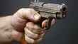 Close-Up of a Hand Holding a Pistol Aimed Forward