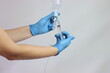 © JFontan - Healthcare care professional injecting drug in the saline solution to bee injected in an infusion set