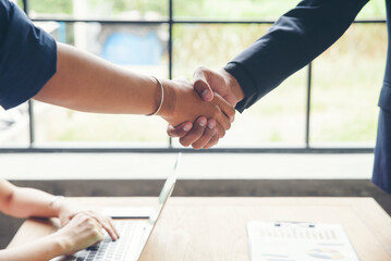 two businessmen shake hands after success deal and finishing work with happy corporate employee and 