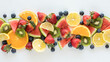 A long narrow row of fresh fruit pieces against a white background.