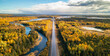 Highway Road by vibrant fall season color trees. Sunny Sky Aerial View. Newfoundland, Canada