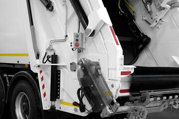 Poster - A modern machine for transporting waste waste with a press and automatic loading and unloading, rear view of the mechanization and trash can