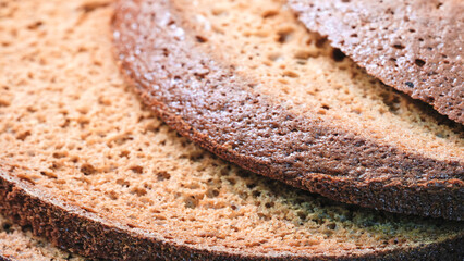 Poster - A close up of a slice of bread with a brown crust. The bread is cut into slices and stacked on top of each other