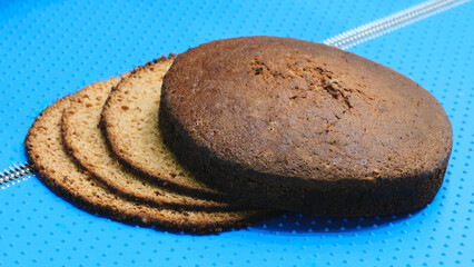 Poster - A slice of cake is on top of a blue surface. The cake is cut into four pieces