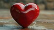 A red heart placed on a wooden table. Suitable for love and romance concepts
