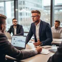 Wall Mural - Business meeting in progress with four people in suits