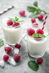 Poster - Fresh milk in glasses with raspberries and mint leaves, perfect for food and drink concepts