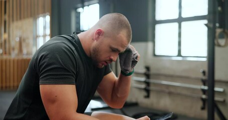 Athlete, man and phone in gym for relax with sweating, break and tired of exercise, workout and training. Bodybuilder, person and smartphone for communication, text message or fitness progress on app