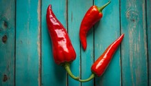 Stunning Overhead Shot Of Three Vibrant Red Chili Peppers Arranged To Form A Triangular Shape