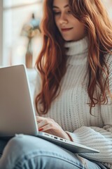 Aufkleber - A woman sitting on a couch using a laptop. Suitable for technology and lifestyle concepts