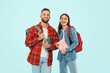 © Prostock-studio - students man and woman standing with backpacks and books, studio