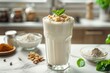 Refreshing protein smoothie with nuts and mint garnish, ideal for bariatric diet plans