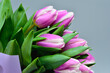 Bouquet of purple tulips on a gray background