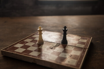 Wall Mural - Chess board game concept of business ideas and competition and strategy ideas concep. Chess figures on a dark background with smoke and fog. Selective focus