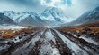 A beautiful scenery of a muddy and rocky road with snowy mountains. Generative AI.