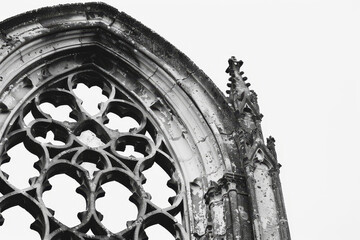 Wall Mural - A close-up of an old Gothic window, its intricate tracery and weathered stone standing out starkly against a pure white background.