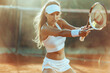 Young girl playing tennis on tennis court