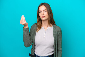 Wall Mural - Young caucasian woman isolated on blue background making Italian gesture