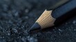 Close-up view of a pencil on a black background, suitable for educational or artistic concepts