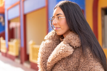 Poster - Young brunette woman at outdoors With glasses