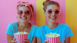 two girls with popcorn