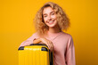 © luismolinero - Young pretty blonde girl over isolated colorful background holding a suitcase