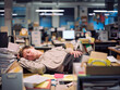 Employee Asleep at Messy Office Desk