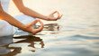 A person is sitting in the water on a beach, practicing yoga with various poses and stretches