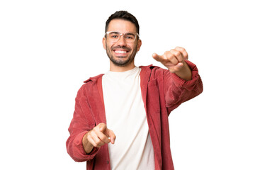 Wall Mural - Young handsome caucasian man over isolated chroma key background pointing front with happy expression