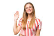 Young beautiful woman over isolated background saluting with hand with happy expression