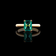 Wall Mural - Beautiful yellow gold ring with diamonds and emerald on a black background