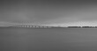 panoramic photo of the ile de re bridge in the fog. monochrome shot