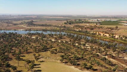 Wall Mural - Fast motion flying over Murray river at Red cliffs town in Victoria – scenic landscape 4k.
