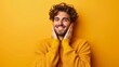 © starush - A man in a yellow sweater smiling with his hands on the sides of his face, AI