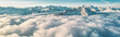 Panoramic view of snow capped mountains surrounded by clouds. Winter landscape with snow covered mountains panorama banner
