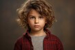 Portrait of a cute little boy with curly hair. Studio shot.