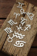 zodiac signs on wooden table, above view