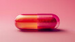 A transparent pink and red capsule pill, on a pink background.