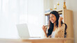 © Monster Ztudio - Funny euphoric young asian woman celebrating winning or getting ecommerce shopping offer on computer laptop. Excited happy girl winner looking at notebook celebrating success