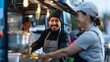 The grinning faces of workers handing out orders at a popular food truck parked outside the stadium offering a unique dining experience for fans.