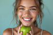 woman with perfect teeth biting an apple