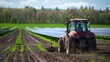 An electric tractor plowing the fields its battery charged by the solar panels showcasing the farms commitment to ecofriendly and . AI generation.