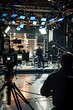 A behind-the-scenes glimpse of the production crew coordinating lighting and sound equipment for a dynamic business talk show segment, Generative AI