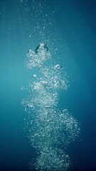 Poster - Sunlight beams filter through the deep, crystal-clear, blue-turquoise water, casting a beautiful curtain of reflections. Air bubbles rise gracefully towards the water's surface, adding to the pictures