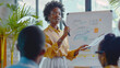 A woman standing confidently, using gestures to explain a presentation to a diverse group of people in a bright, spacious room, Young African American female coach or speaker make flip chart presentat