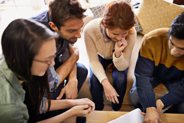 Creative team, meeting and planning with laptop at cafe for discussion or indoor project. Group of people, employees or friends with technology for brainstorming or startup at coffee shop or lounge