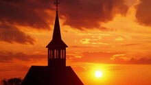 A Rural Church Steeple Rises Against The Fiery Hues Of A Sunset Its Silhouette A Symbol Of Faith In The Tranquil Countryside.